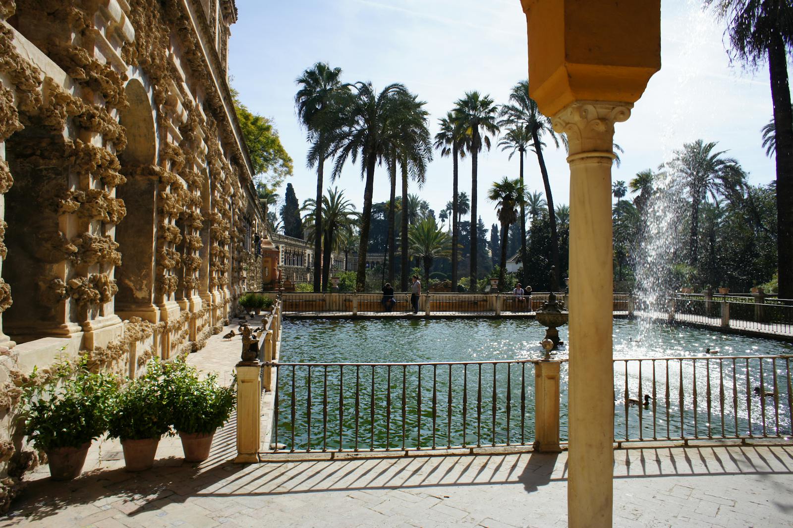 Vedere asupra fântânii și palmierilor din Alcázar-ul din Sevilla